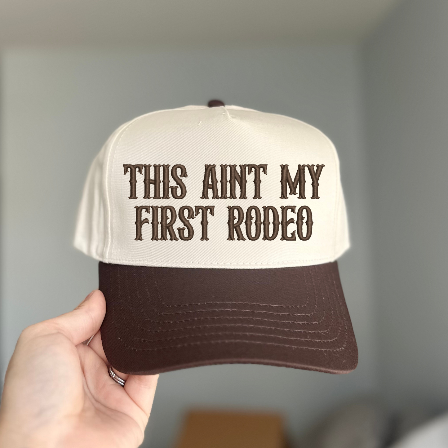 THIS AIN'T MY FIRST RODEO TRUCKER HAT